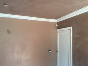 Wall freshly coated with new plaster ready for finishin, ceiling now completed