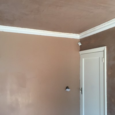 Wall freshly coated with new plaster ready for finishin, ceiling now completed