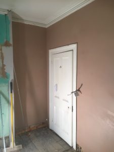 New plaster around door, cornice work saved